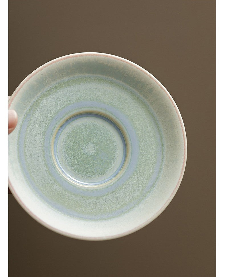 Holding porcelain gaiwan with smooth aurora gradient in cool tones