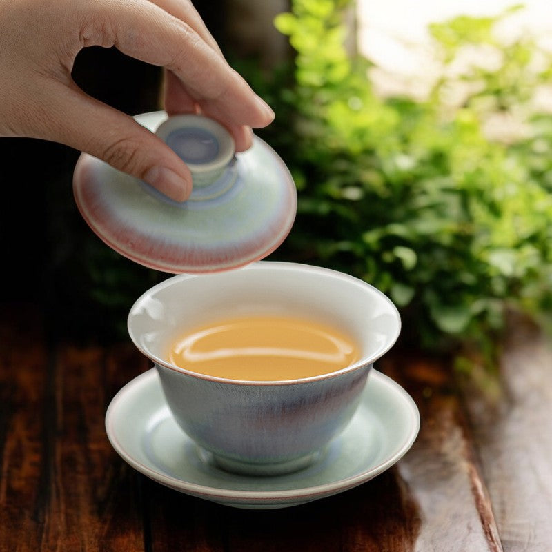 Pouring tea from celestial glaze gaiwan with misty satin finish