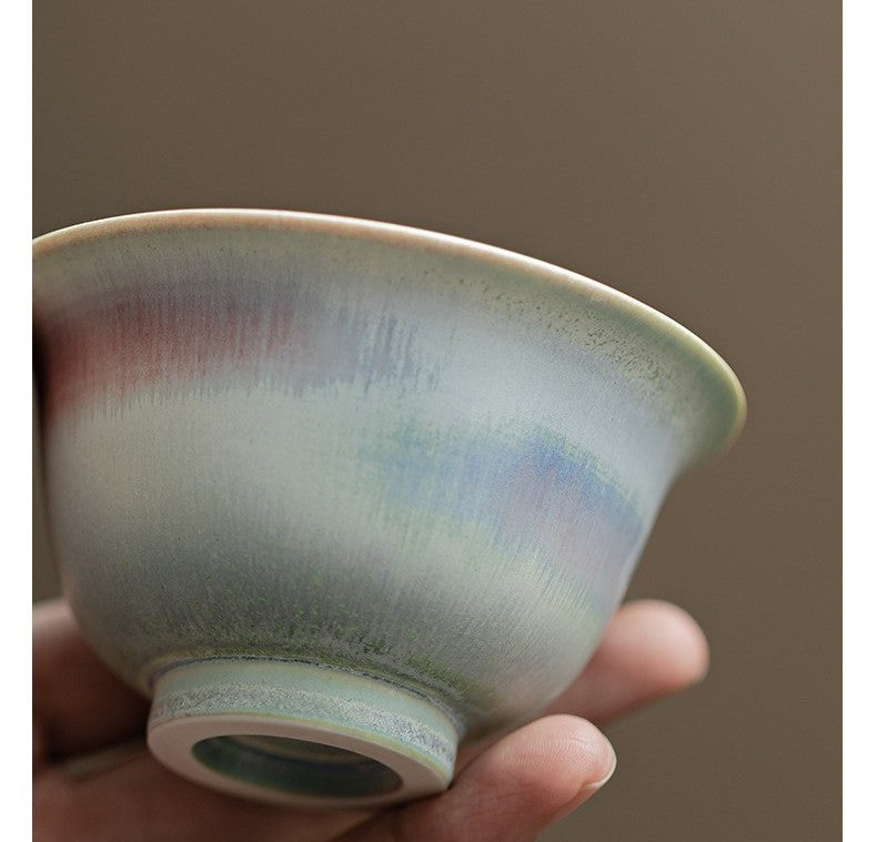 Holding porcelain gaiwan with smooth aurora gradient in cool tones