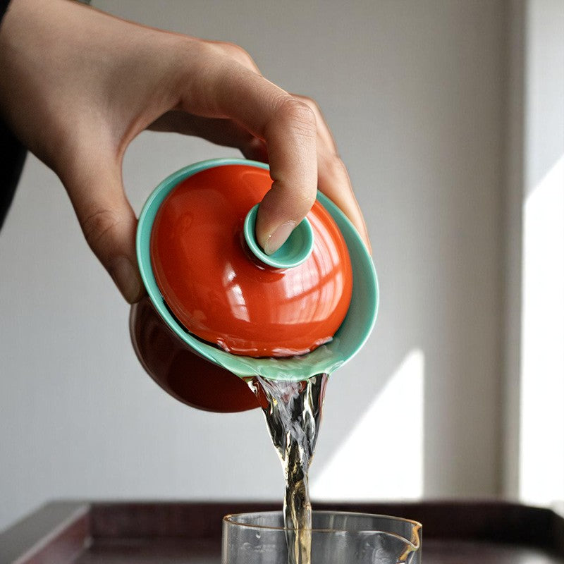 Pouring from red and green gaiwan with easy grip and clean spout