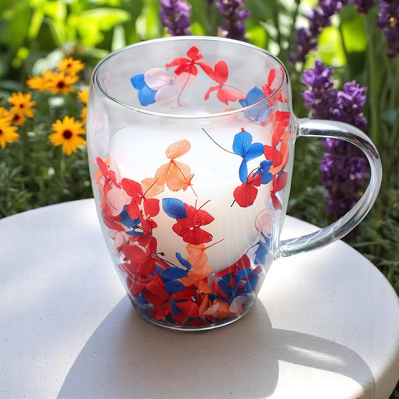Dried flower double glass mug with milk tea in garden sunlight