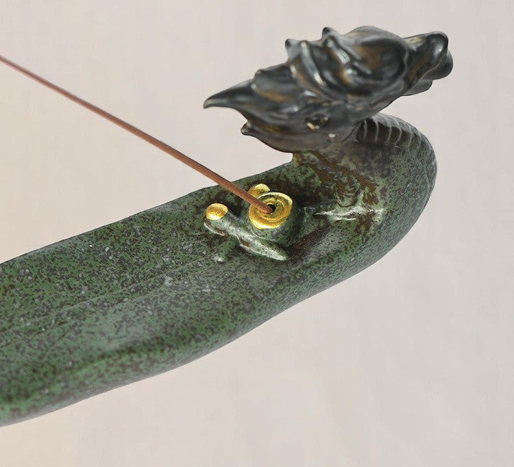 Angled side view of the dragon-shaped incense holder in green ceramic