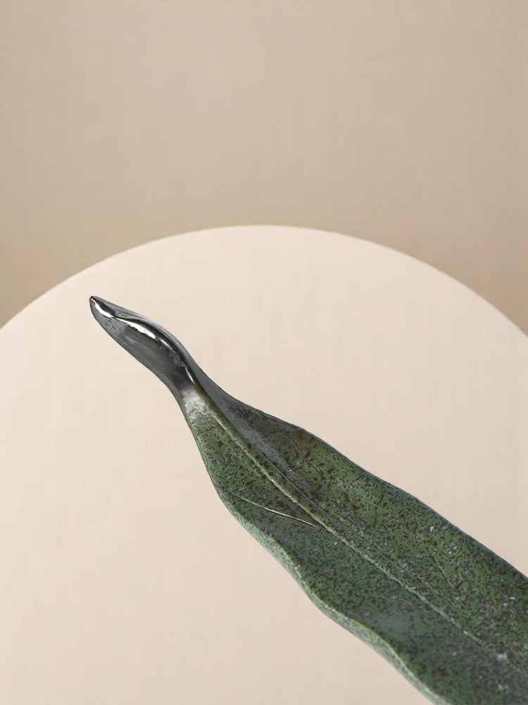 Tail end of the dragon boat incense holder against a beige background
