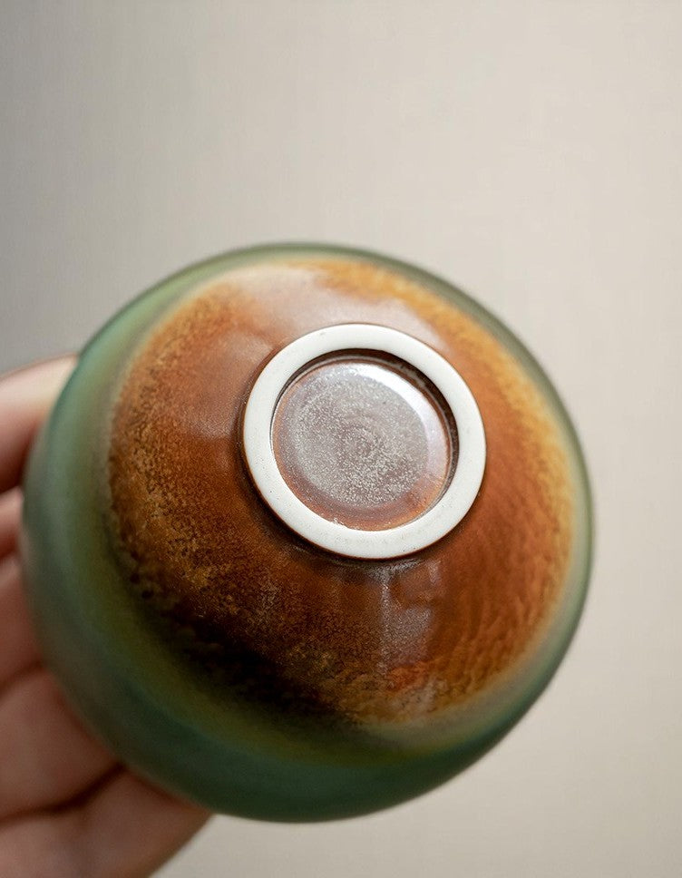Underside of handmade teacup showing natural kiln glaze variation