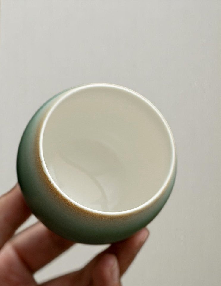 Interior view of egg-shaped ceramic cup with smooth ivory glaze