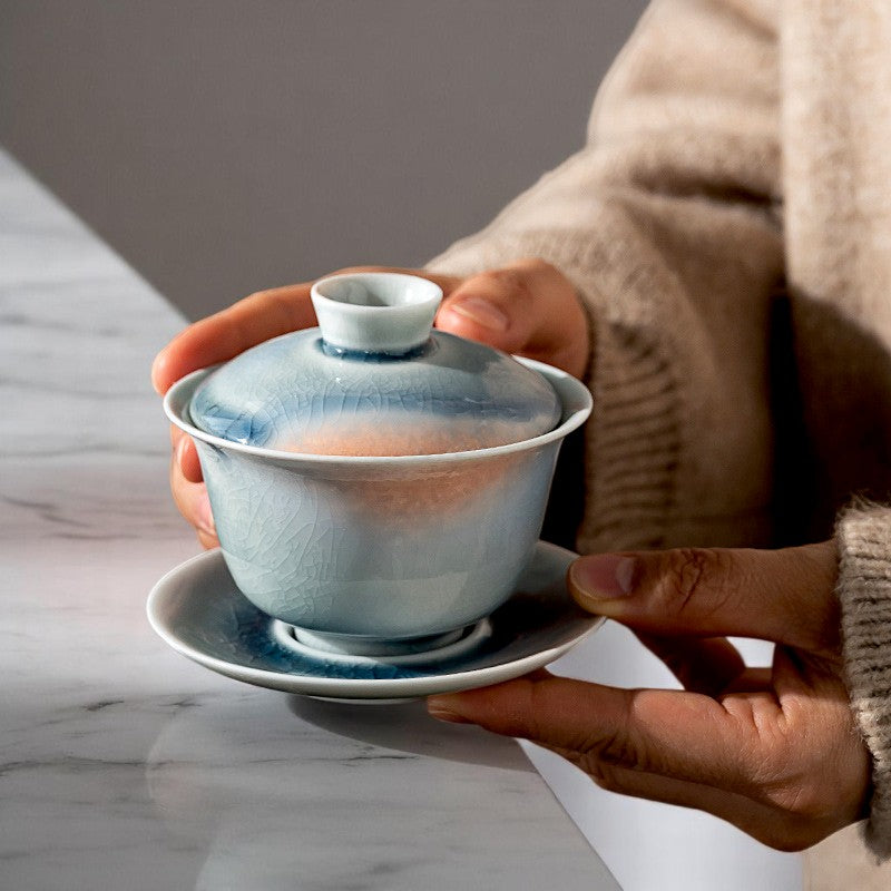 Two-hand pour using handmade teabowl with amber fire-like glaze