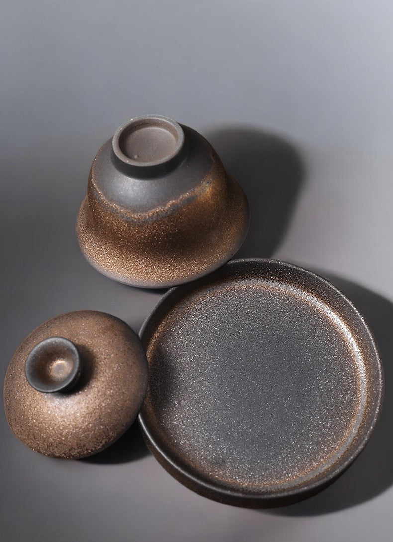 Zen-inspired teaware set showing gaiwan bowl, lid, and saucer parts