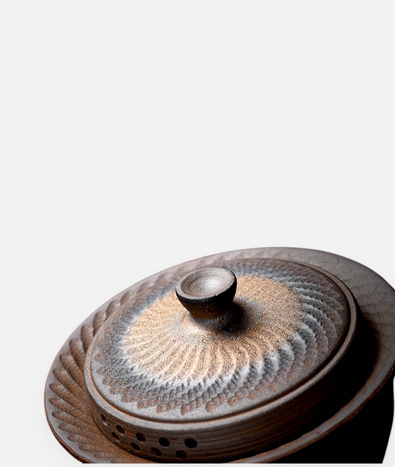 Side view of handcrafted gaiwan with carved lid and bronze gradient