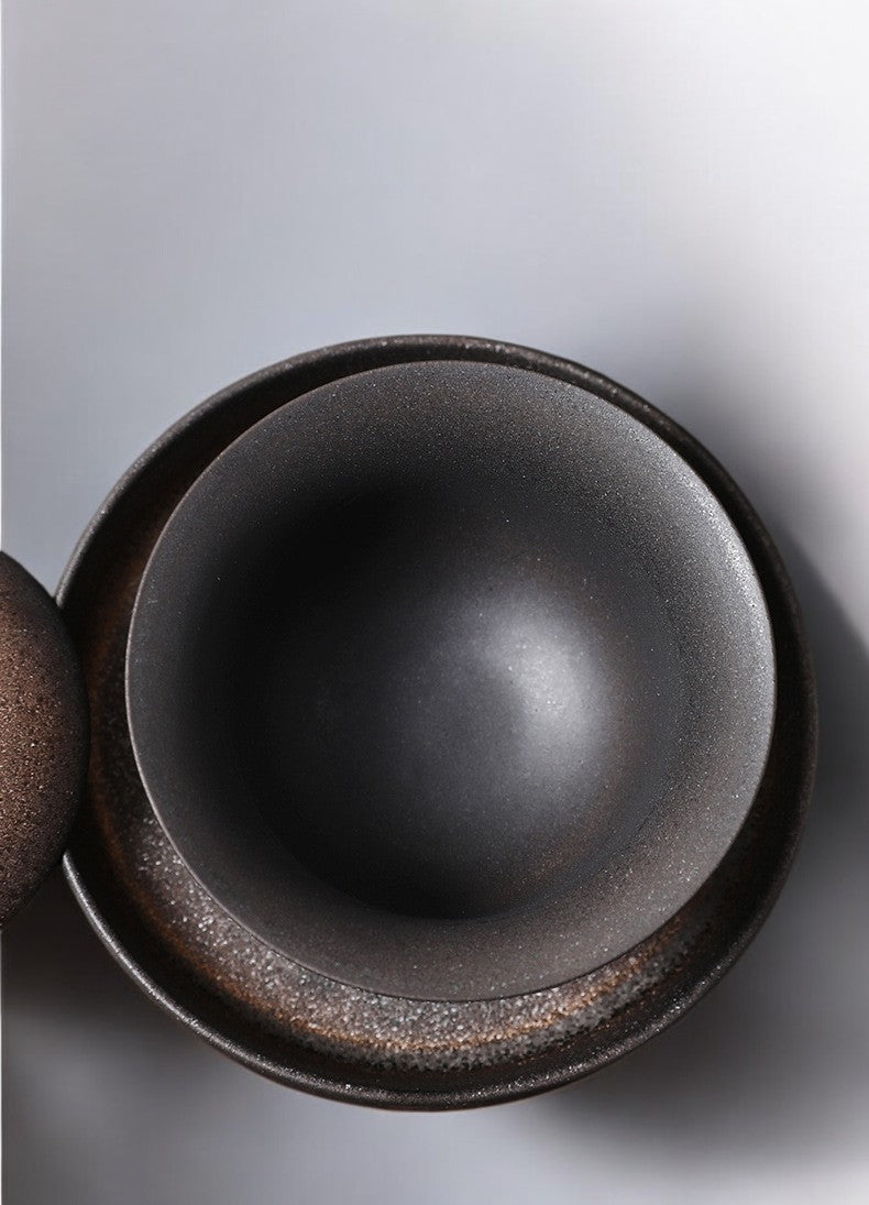 Interior of ceramic gaiwan with matte rust glaze and natural variation