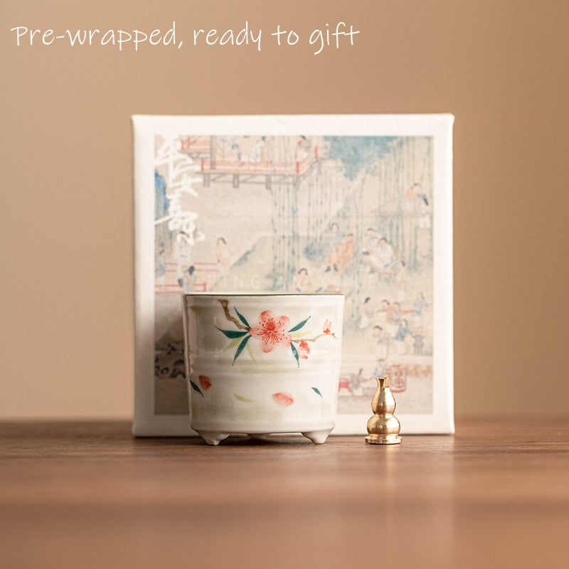 ceramic incense holder with peach blossom motif, in minimalist gift pack.