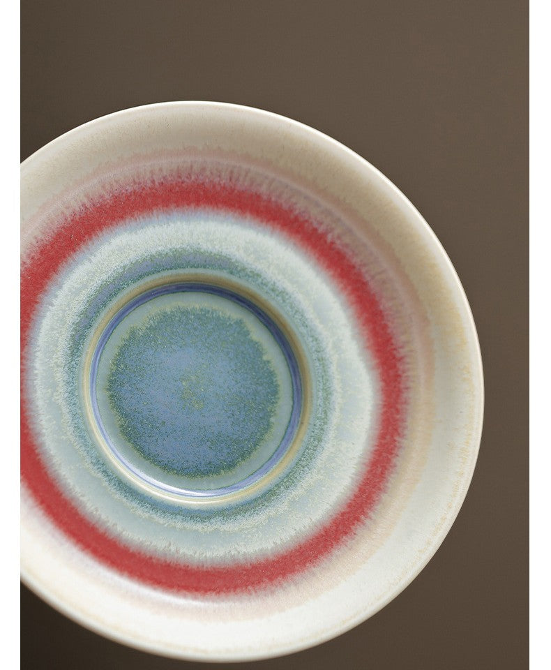 Bottom view of tea bowl showing swirl of glacier blue and crimson tones