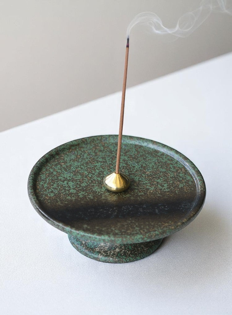 Ceramic incense burner with brass holder and stick incense lit
