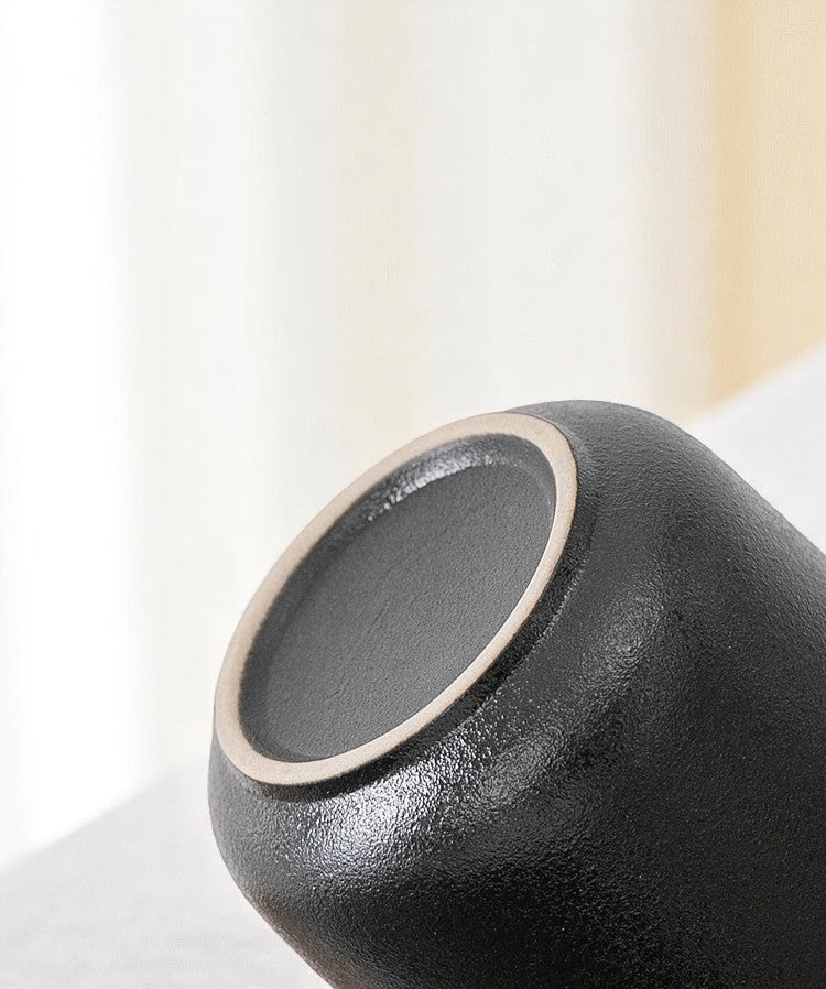 Underside of black ceramic mug with smooth matte glaze finish
