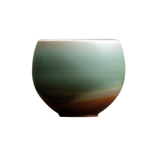 Egg-shaped ceramic teacup with matte misty green and chestnut glaze