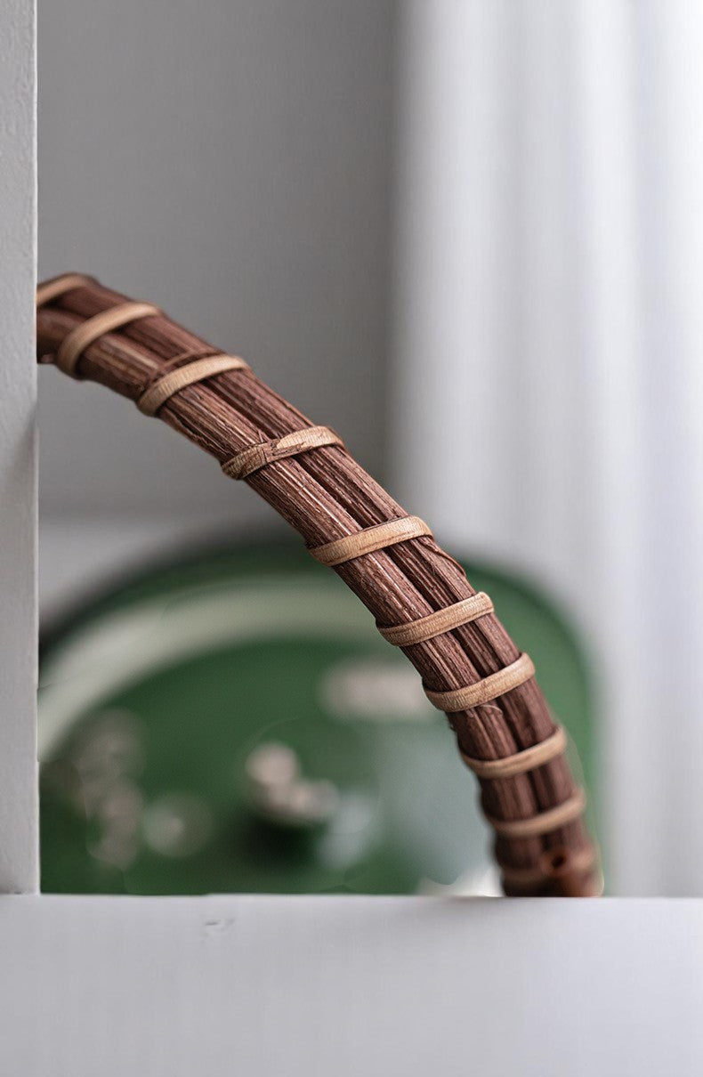 Close-up of Bamboo Handle on Forest Green Ceramic Teapot