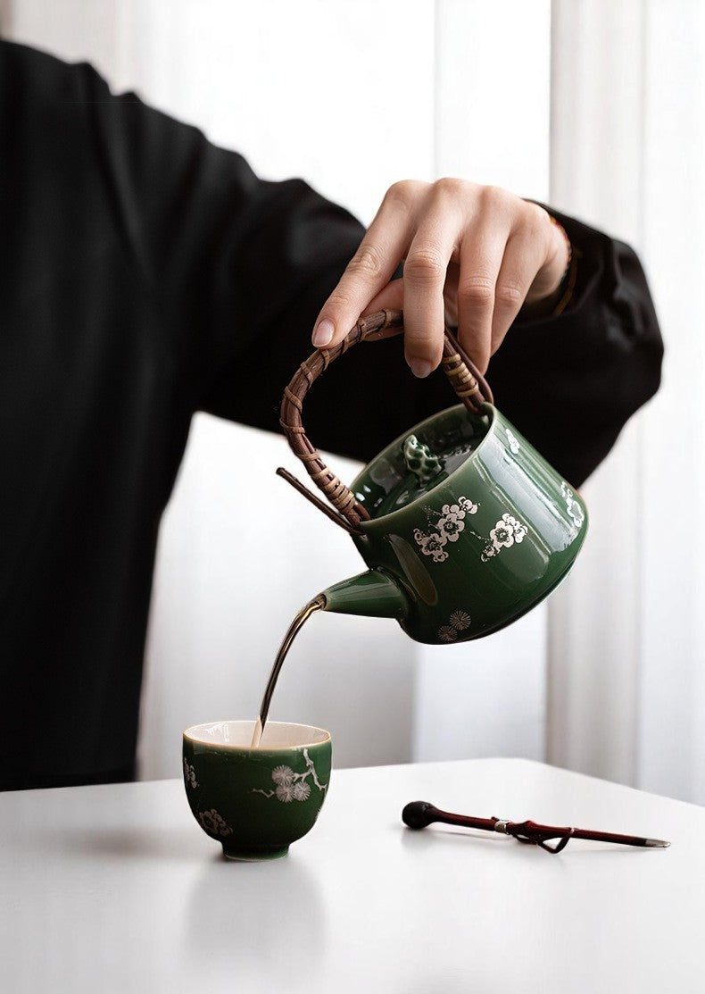 Pouring tea from Forest Green Ceramic Teapot with Bamboo Handle