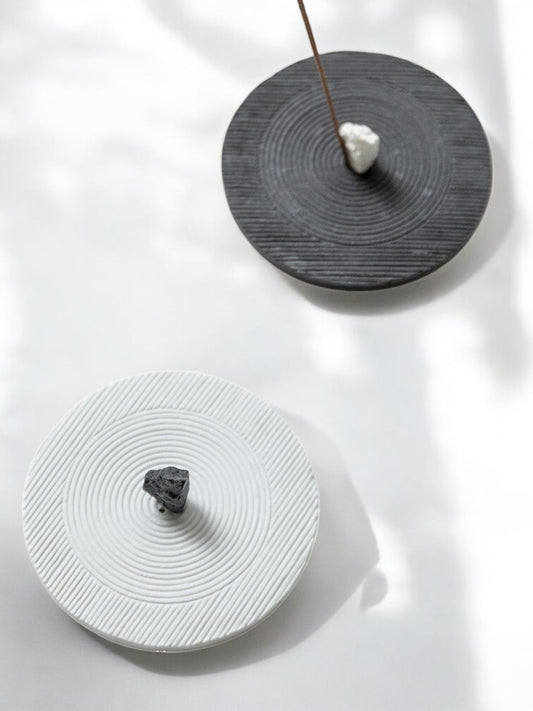 Black and white ceramic incense holders inspired by zen gardens